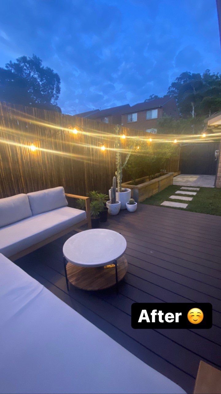 Outdoor entertaining deck at twilight with fairy lights and lounge setting